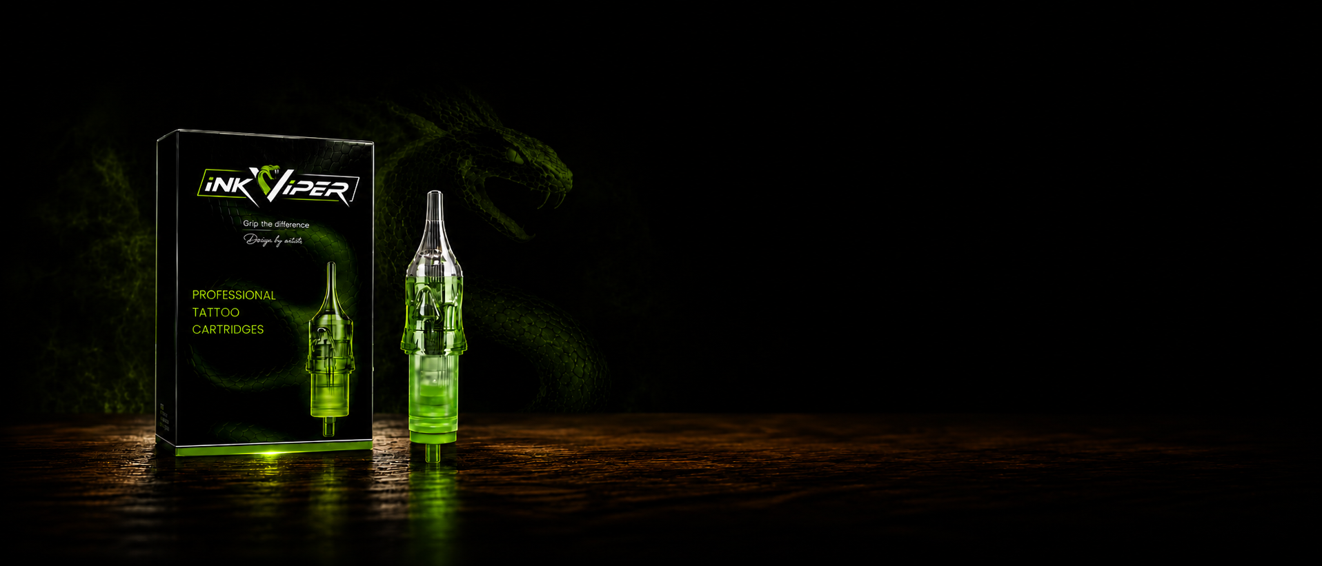 Ink Viper disposable tattoo cartridges shown with their retail box on a dark wooden surface against a black background. The product features a clear glass cartridge filled with glowing green liquid and is illuminated by green light.